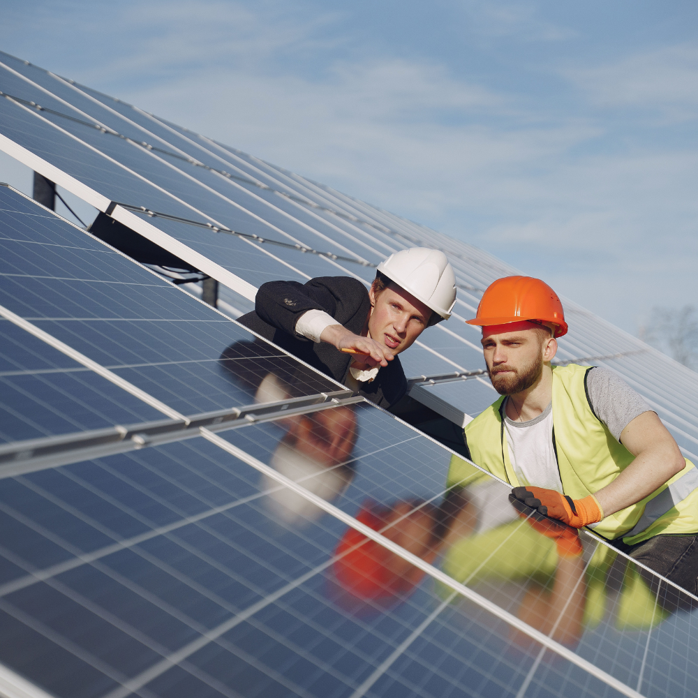 Deux techniciens installant un panneau solaire sur un toit